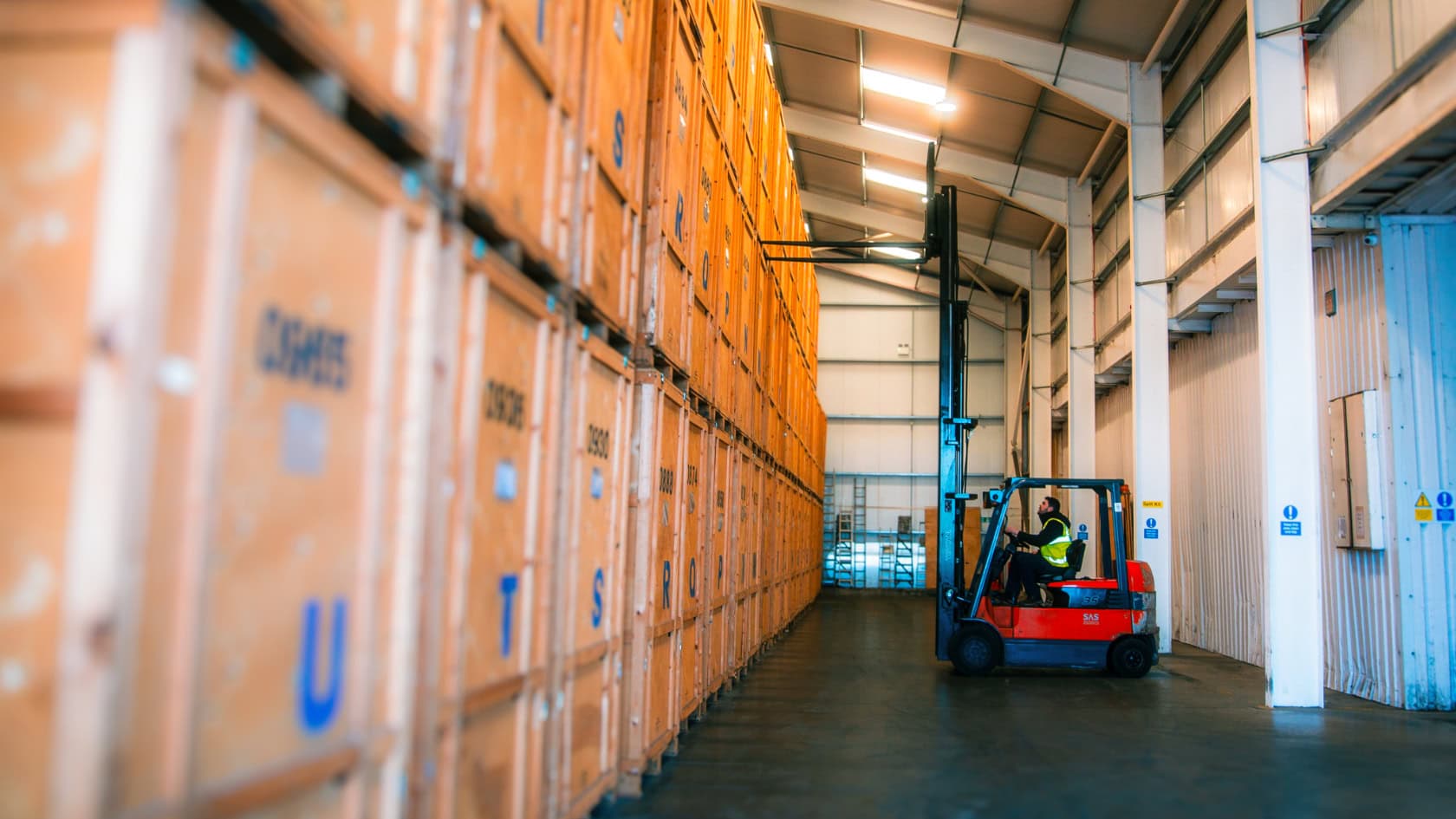 Forklift operator moving wooden storage crates inside Kerr’s secure Edinburgh facility
