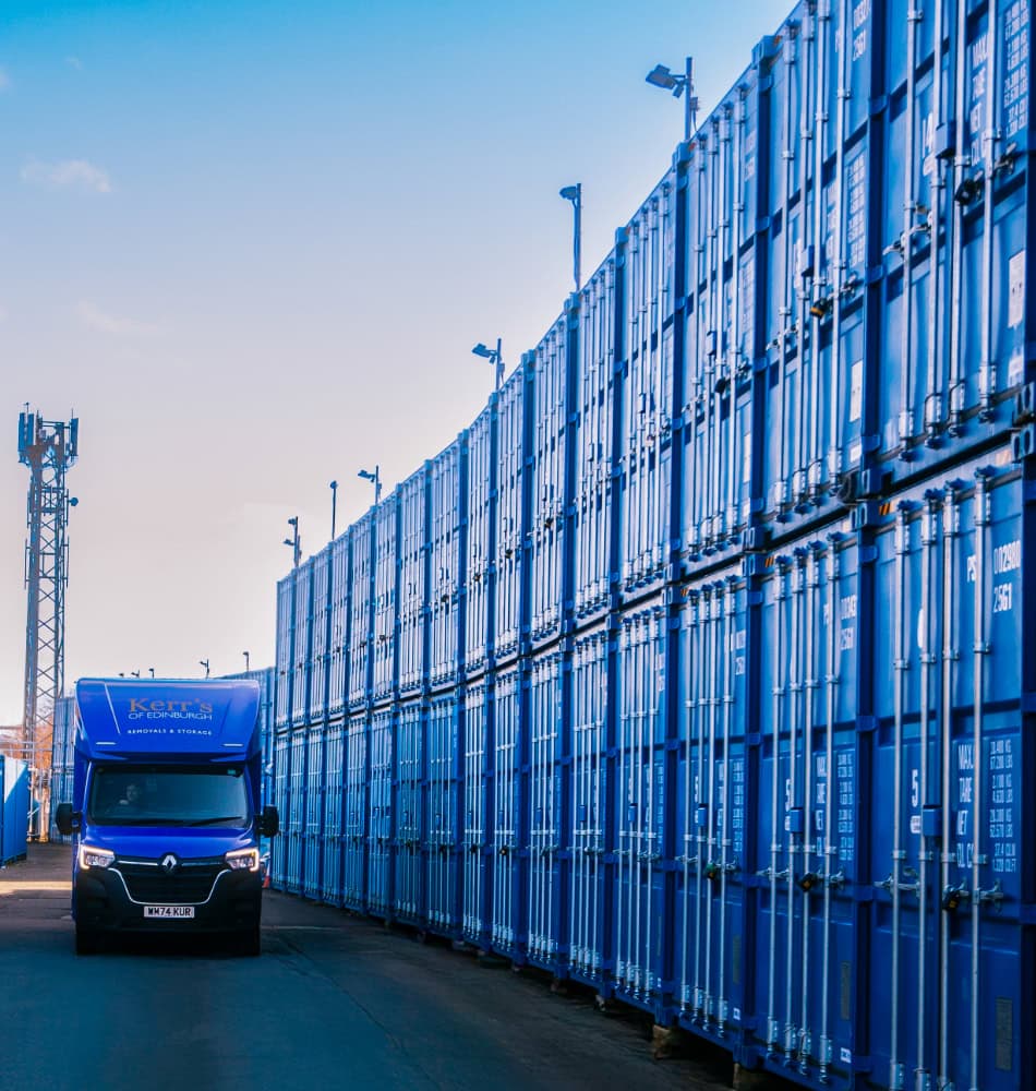 Kerr’s branded van beside rows of secure storage containers at Edinburgh facility