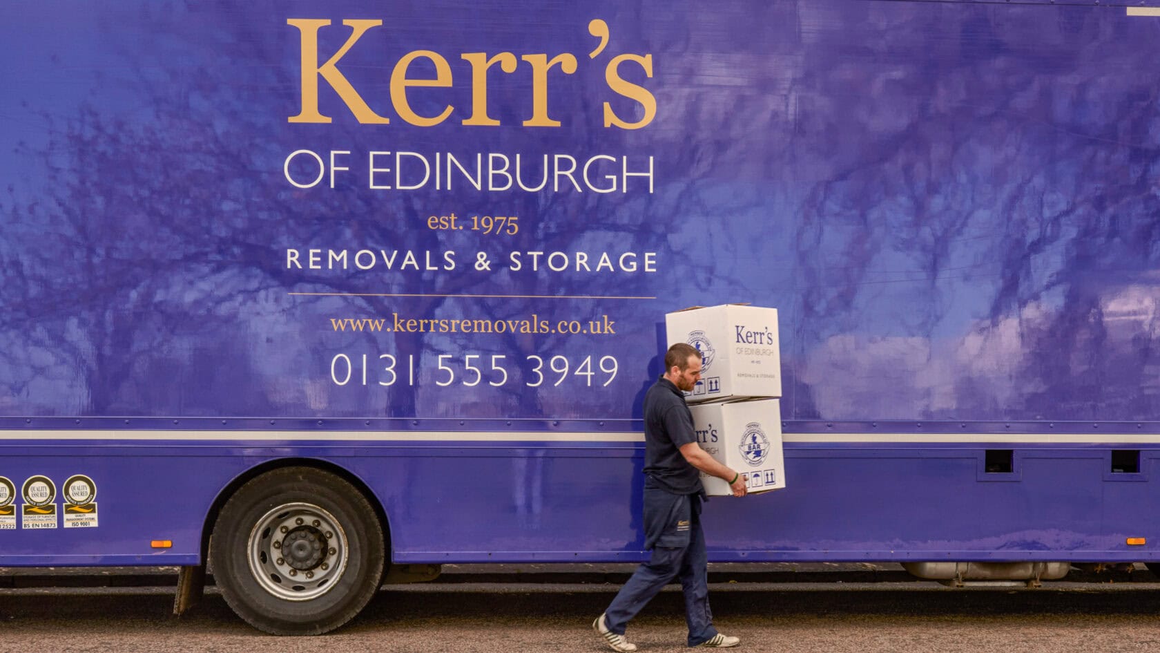 Organisation removals Edinburgh - Kerr's team with branded van during institutional relocation